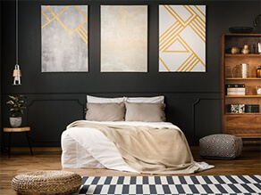 Black Painted Bedroom with Wooden Floorboards and Bookcase